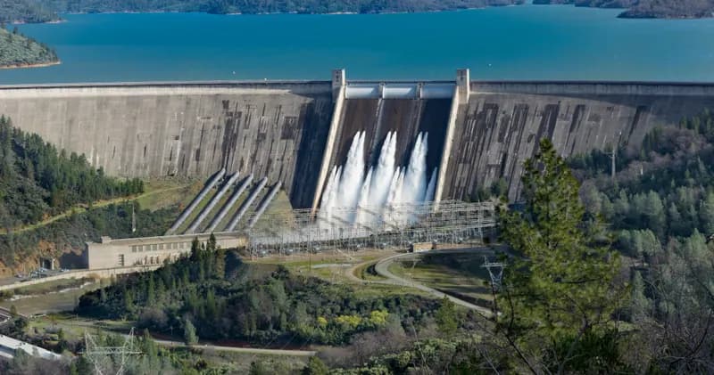 Large dam with water flowing through its spillways