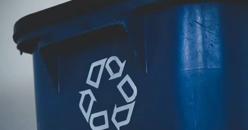 Blue bin with a recycling symbol