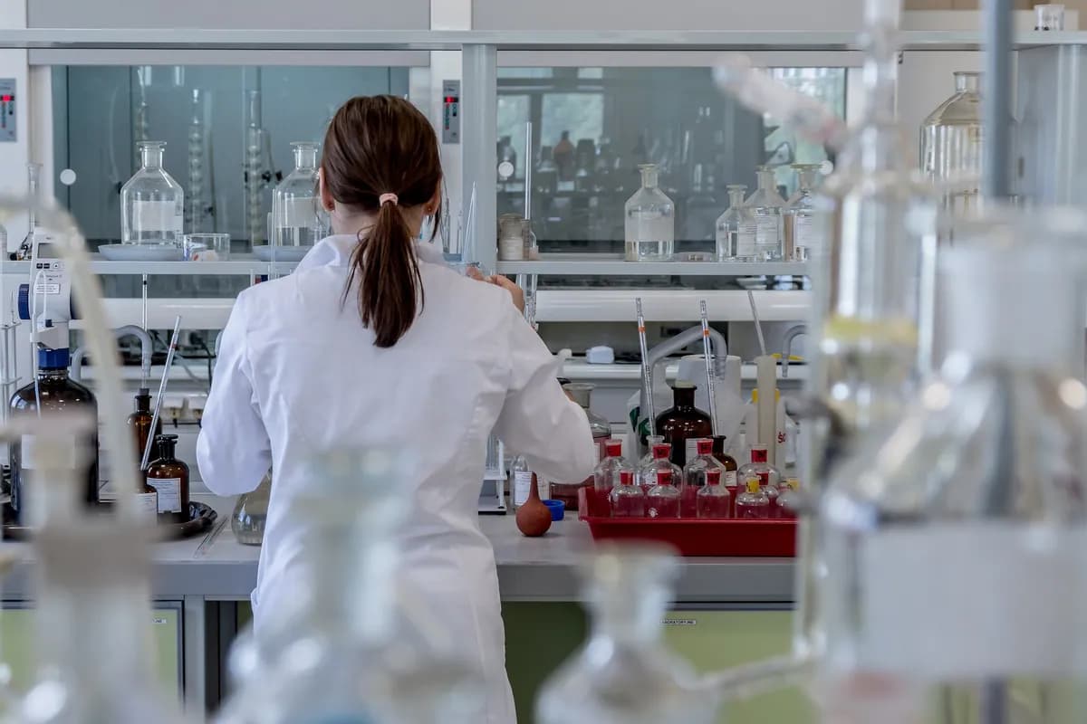 Researcher in a lab coat working at a laboratory bench