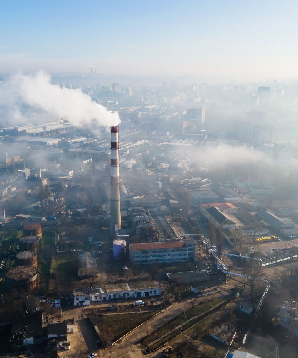 aerial-drone-view-chisinau-thermal-station-with-smoke-coming-out-tube-buildings-roads-fog-air-moldova